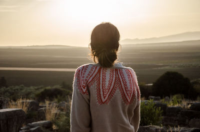 Rear view of woman looking at camera