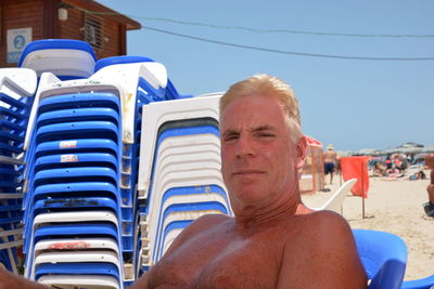 Portrait of shirtless man on beach