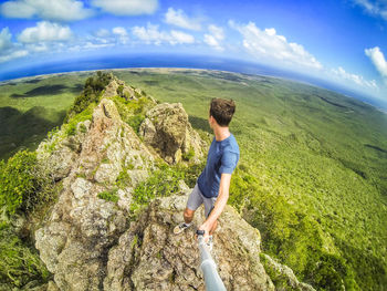 Young man on the top of a dangerous cliff