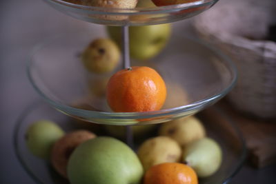 Close-up of fruits in glass bowl on table