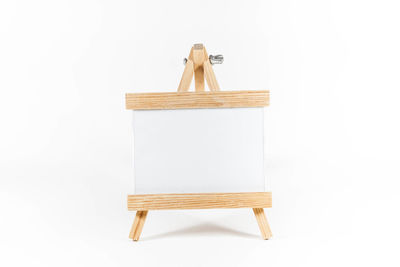 Close-up of blank easel against white background