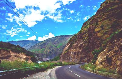 Road amidst mountains against sky