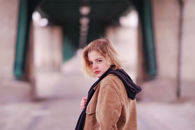 Portrait of young woman standing outdoors