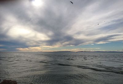 Scenic view of sea against cloudy sky