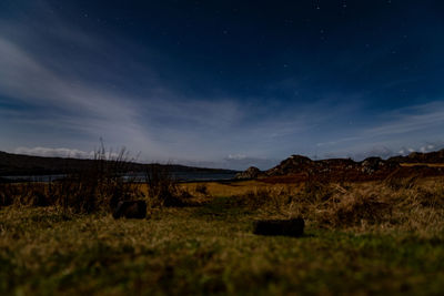 Scenic view of field against sky at night