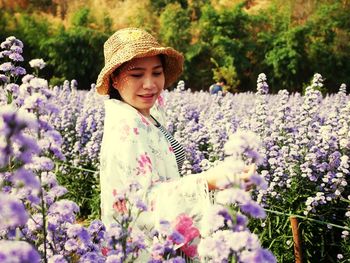 Woman standing on purple flowering plants