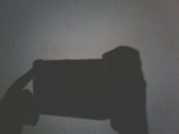 Close-up of silhouette person using mobile phone