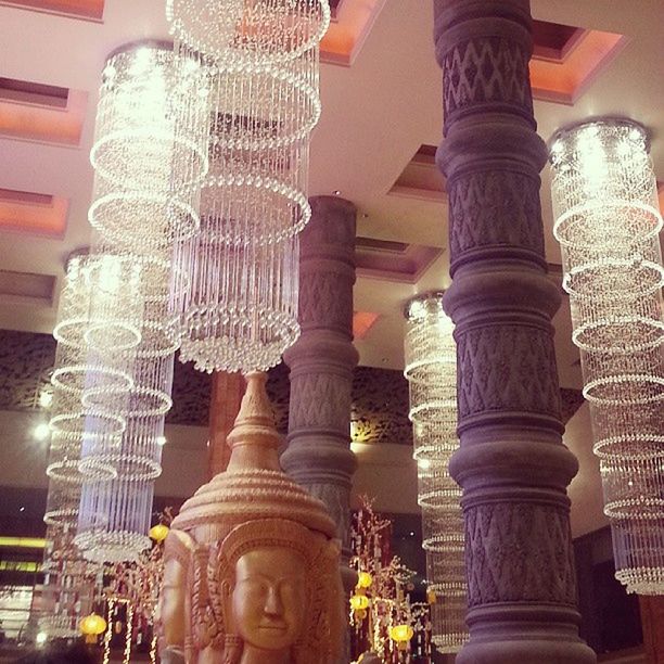 indoors, architecture, built structure, architectural column, low angle view, building exterior, decoration, window, design, art and craft, glass - material, building, ornate, pattern, no people, sculpture, in a row, art, lighting equipment, architectural feature