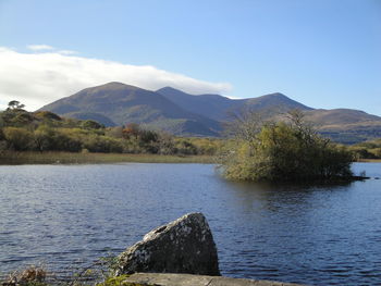 Scenic view of lake and mountains against sky