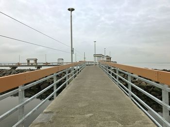 Bridge over sea against sky