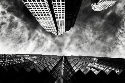 Low angle view of modern building against cloudy sky