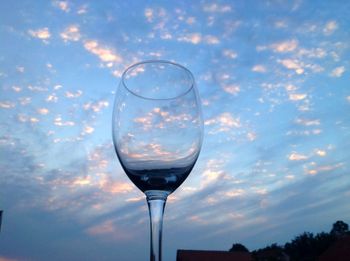 Close-up of wineglass against sky