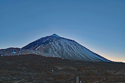 Scenic view of mountain against clear blue sky