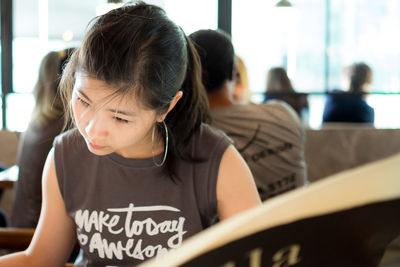 Close-up of young woman in library