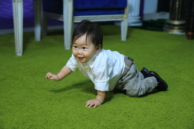 Portrait of cute baby boy on grass