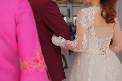 Rear view of couple walking in wedding hall