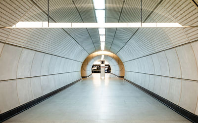 Rear view of man walking on escalator