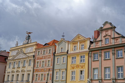 Low angle view of building against cloudy sky