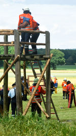 Rear view of men working on field
