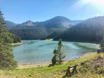 Scenic view of lake and mountains against sky