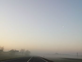 Road against clear sky during sunset