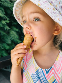 Portrait of young woman eating food