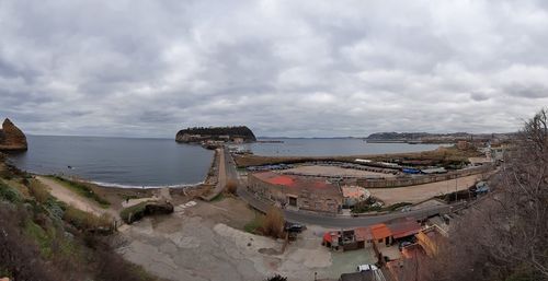 Panoramic view of abandoned ship on beach against sky