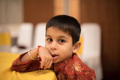 Close-up of cute girl looking away at home