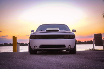 Car on road against sky during sunset