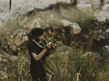 Side view of young man standing on land