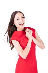 Portrait of a smiling young woman against white background