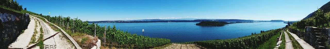 Panoramic view of suspension bridge over sea against sky