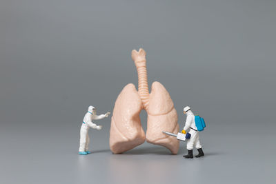 Close-up of figurine on table against black background