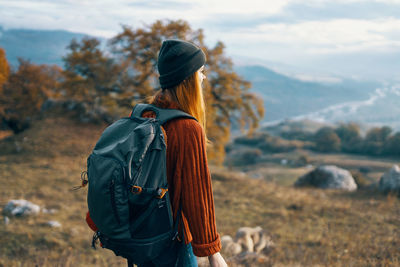 Rear view of woman looking at camera