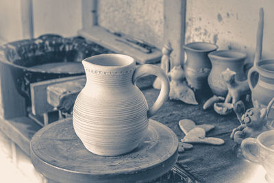 Old vintage photo. clay jug on a potter's wheel close-up. copy spase. old vintage style.