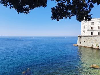 Scenic view of sea against clear blue sky