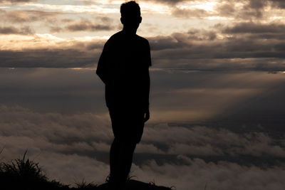 Silhouette man standing against sky during sunset