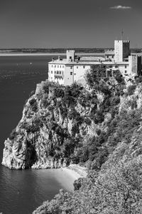 High angle view of buildings by sea against sky