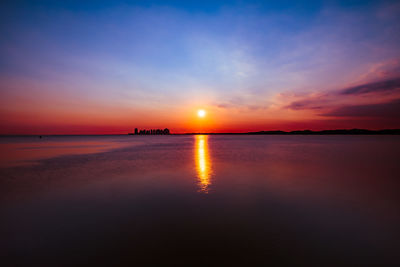 Scenic view of sea against romantic sky at sunset