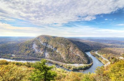 Scenic view of delaware water gap by mountains against cloudy sky