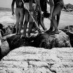 Group of friends on beach rock