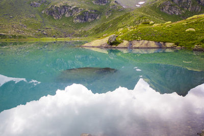 Wide angle lens landscape and mountain reflections in okhrotskhali in svaneti, georgia.