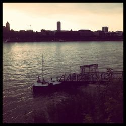 Boats in river at sunset