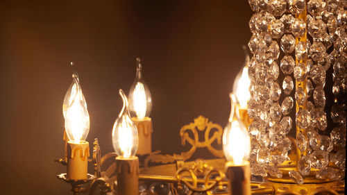 Close-up of lit candles in the dark