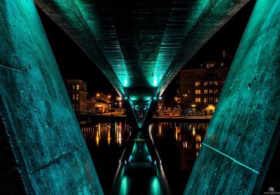 Bridge against illuminated buildings