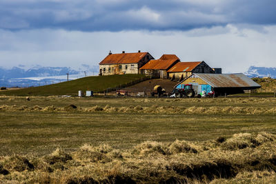 Houses on field against sky