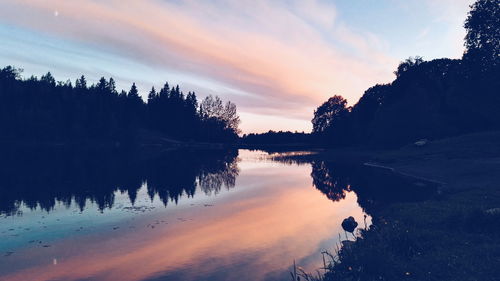 Scenic view of calm lake at sunset