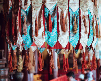 Close-up of decorations hanging in store for sale