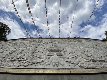 Low angle view of sculpture against building