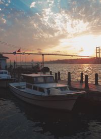 View of boats in river at sunset